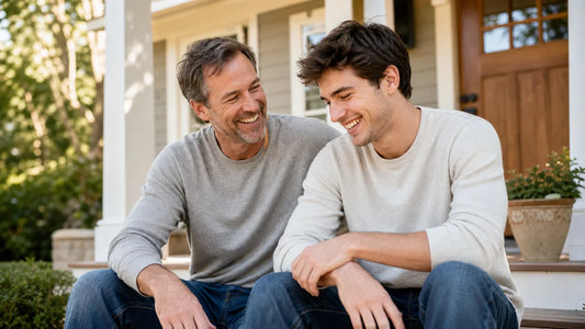 Parent and adult son sharing a warm moment on a sunlit porch