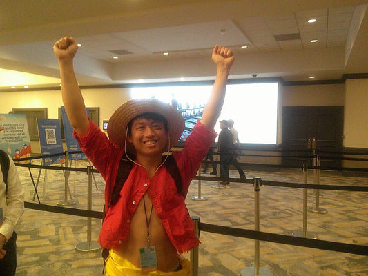 Luffy cosplayer wearing a straw hat and red vest at Anime Boston