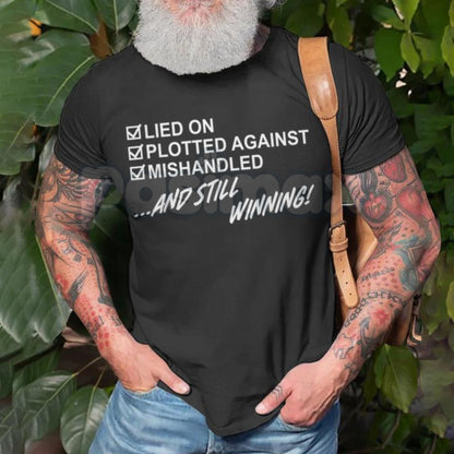 "Still Winning" Resilience T-Shirt - Lied On Plotted Against Mishandled Graphic Tee, Inspirational Survival Quote Shirt, Motivational Hustle Apparel, Premium Heavyweight Unisex Success Top, Overcomer Statement Shirt