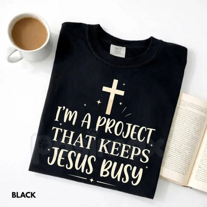 Comfort Colors® "I'm A Project That Keeps Jesus Busy" T-Shirt – Funny Christian Graphic Tee, Sarcastic Faith Humor Shirt, Aesthetic Religious Gift for Her