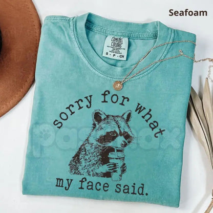Comfort Colors® "Sorry For What My Face Said" T-Shirt – Sarcastic Raccoon Graphic Tee, Funny Trash Panda Meme Shirt, Moody Aesthetic Gift for Her