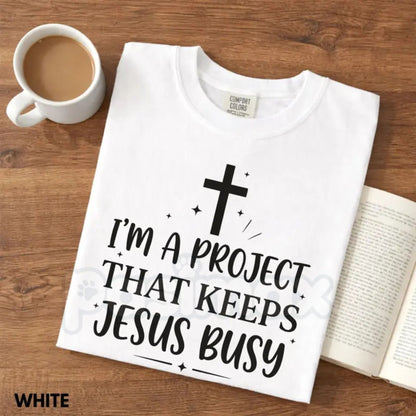 Comfort Colors® "I'm A Project That Keeps Jesus Busy" T-Shirt – Funny Christian Graphic Tee, Sarcastic Faith Humor Shirt, Aesthetic Religious Gift for Her