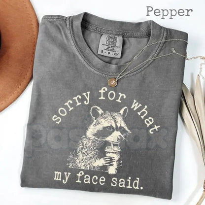 Comfort Colors® "Sorry For What My Face Said" T-Shirt – Sarcastic Raccoon Graphic Tee, Funny Trash Panda Meme Shirt, Moody Aesthetic Gift for Her