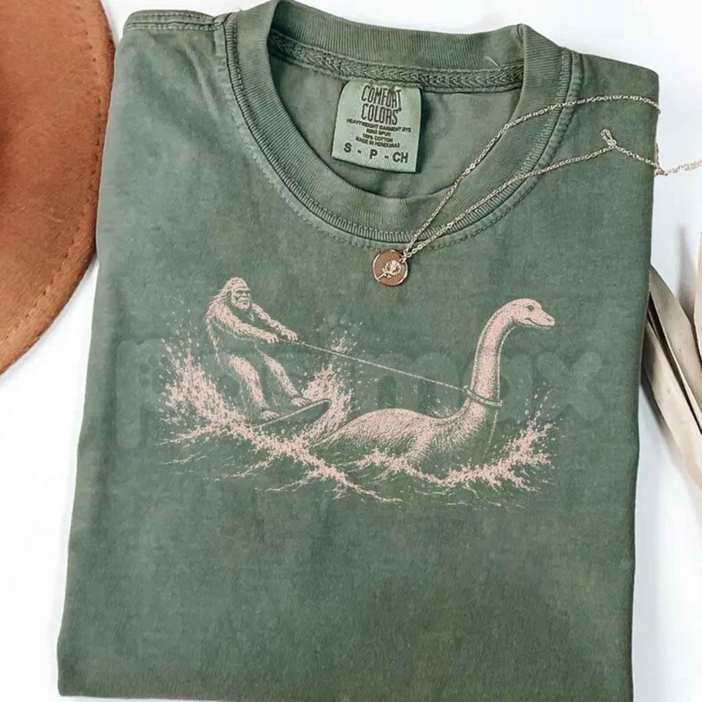 Comfort Colors® Funny Bigfoot & Loch Ness Monster T-Shirt – Retro Cryptid Waterskiing Graphic Tee, Vintage Mythical Creature Lake Life Unisex Top