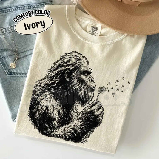 Comfort Colors® "Bigfoot Dandelion" T-Shirt – Vintage Sasquatch Nature Graphic Tee, Retro Aesthetic Wildflower Cryptid Unisex Top-Pasimax