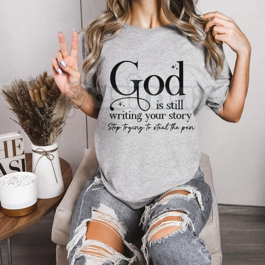 "God Is Still Writing Your Story" Christian T-Shirt – Inspirational Faith Graphic Tee, Premium 100% Cotton Grace Top, Soft Lived-In Heavyweight Storyteller Shirt, Made in USA-Pasimax