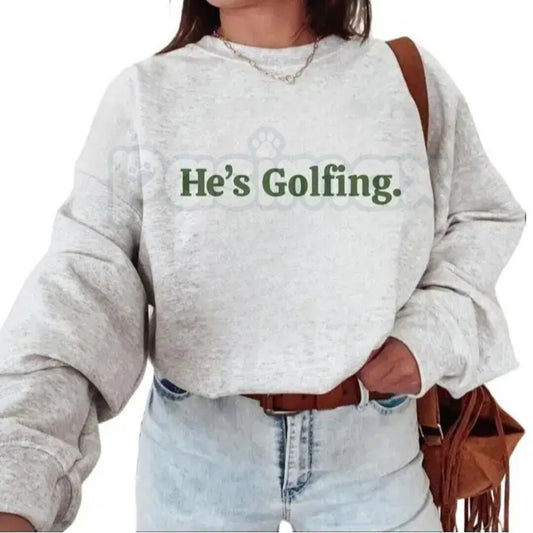 He’s Golfing Sweatshirt | Funny Golf Widow Crewneck | Humorous Country Club Pullover | Sarcastic Weekend Golfer Jumper | Aesthetic Golf Humor Shirt | Soft Cozy Sporty Lifestyle Top-Pasimax