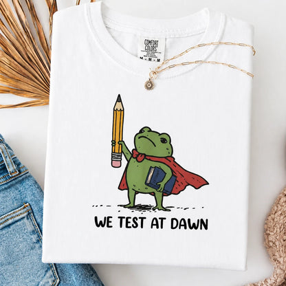 Comfort Colors® "We Test At Dawn" Funny Teacher Frog T-Shirt – Sarcastic Exam Day Graphic Tee, Vintage Testing Season Shirt, Aesthetic Educator Humor Top